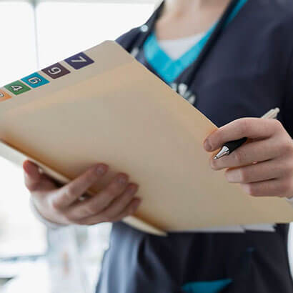 Medical professional with patient file.